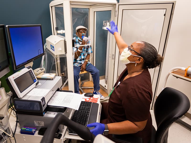 As pulmonary respiratory therapist Kimberly Lockett directs him to breathe in and out, Jackson lung cancer patient Sammie Bass undergoes pulmonary function testing to gauge how well he can breathe.